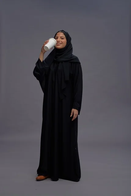 Saudi Woman in Black Abaya Holding Coffee Cup