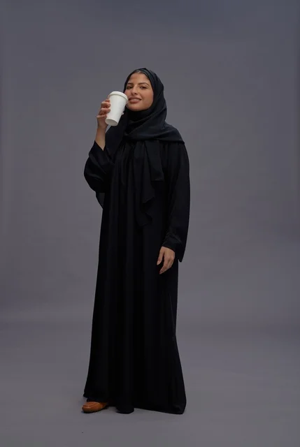 Saudi Woman in Black Abaya Holding Coffee Cup