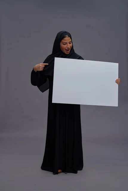 Saudi Woman in Black Abaya Holding Blank White Board