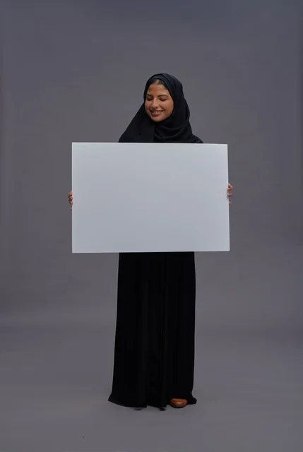 Saudi Woman in Abaya Holding Blank White Board Sign