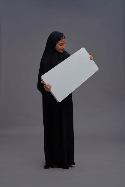 Saudi Woman in Black Abaya Holding Blank White Board