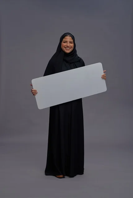 Saudi Woman in Abaya Holding Blank White Board