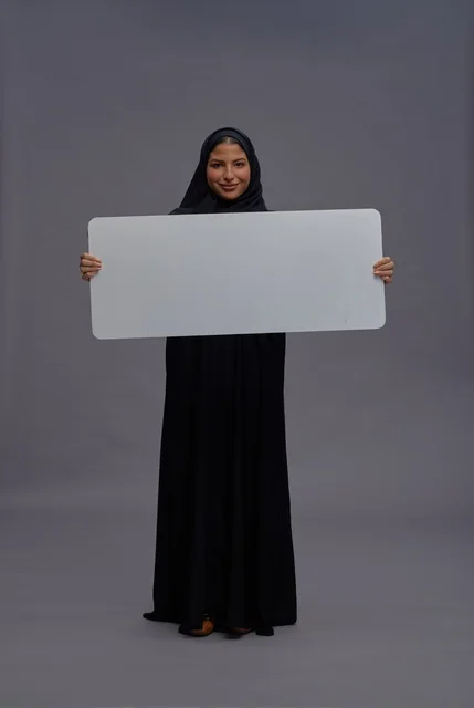 Saudi Woman in Black Abaya Holding Blank White Board