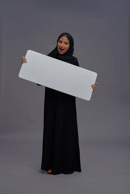 Saudi Woman in Black Abaya Holding Blank White Board