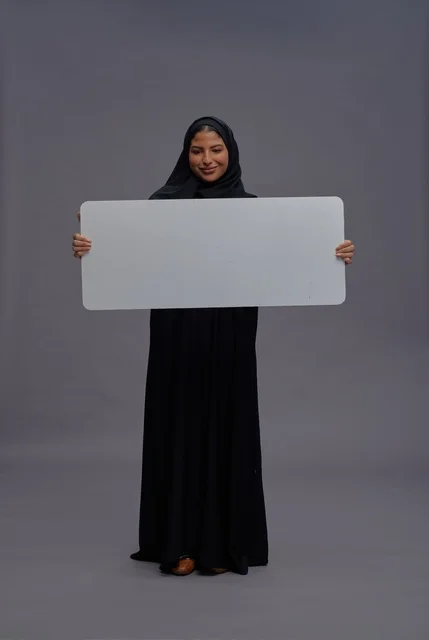 Saudi Woman in Abaya Holding Blank White Board