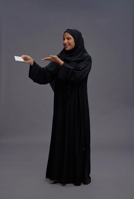 Saudi Woman in Abaya Holding Blank Card