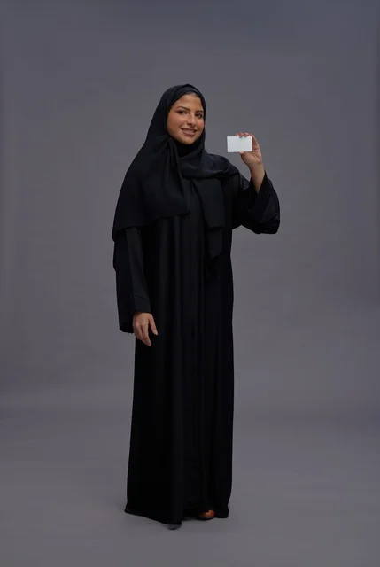 Saudi Woman in Abaya Holding Blank Card Studio Shot Saudi Woman in Abaya Holding Blank Card Studio Shot