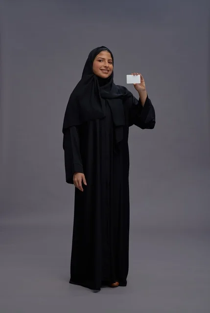 Saudi Woman in Black Abaya Holding Blank Business Card Saudi Woman in Black Abaya Holding Blank Business Card