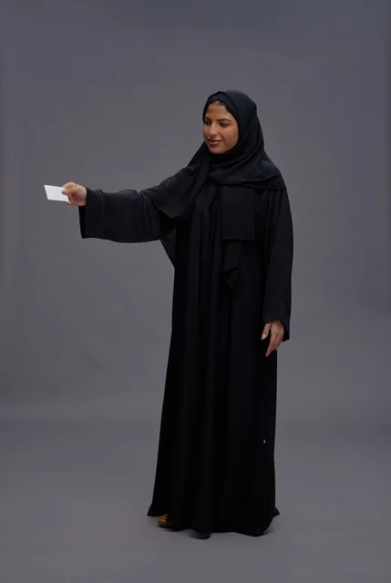 Saudi Woman in Black Abaya Holding Blank Business Card