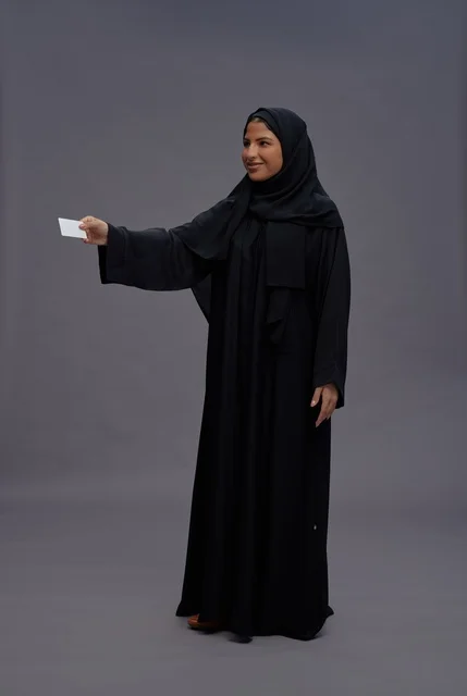 Saudi Woman in Abaya Holding Blank Card