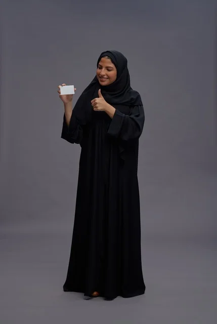 Saudi Woman in Black Abaya Holding Blank Card Thumbs Up