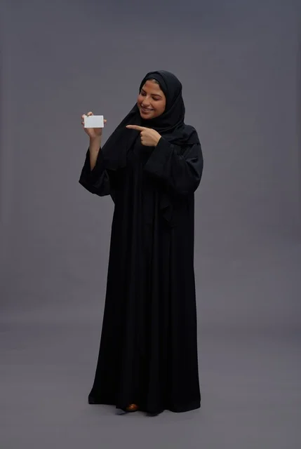 Saudi Woman in Abaya Holding Blank Card Studio Shot Saudi Woman in Abaya Holding Blank Card Studio Shot