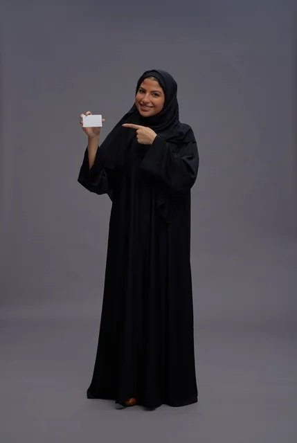 Saudi Woman in Abaya Holding Blank Card