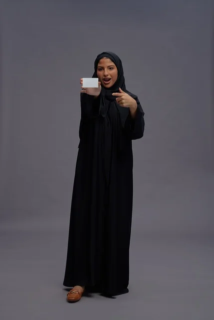 Saudi Woman in Black Abaya Holding Blank Card