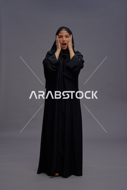 Surprised Saudi Woman in Black Abaya on Grey Background