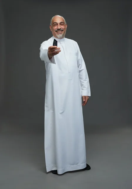 Senior Saudi Man Holding Car Key in Studio Senior Saudi Man Holding Car Key in Studio