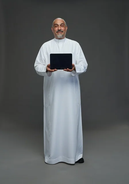 Senior Saudi Man Holding Digital Tablet in Studio