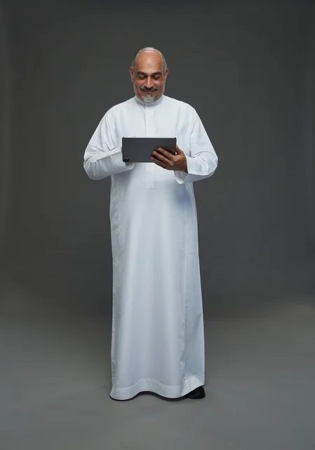 Elderly Saudi Man Using Digital Tablet in Studio