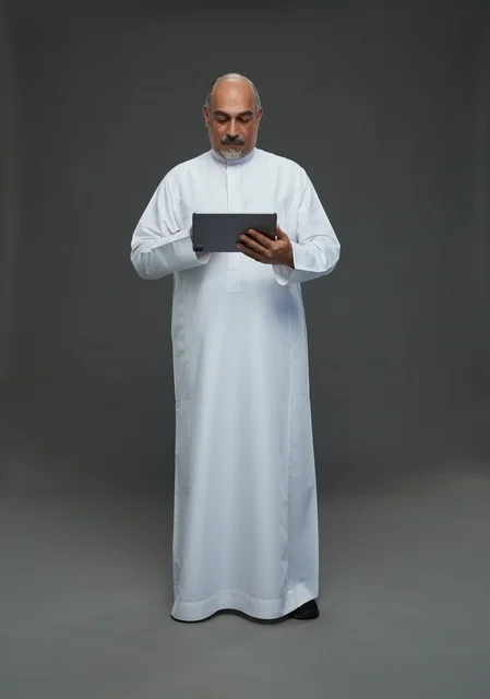 Elderly Saudi Man Using Tablet in Studio
