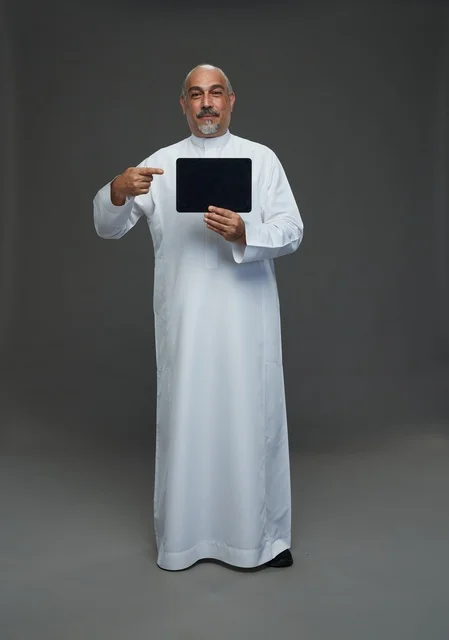 Saudi Elderly Man Pointing at Tablet Screen