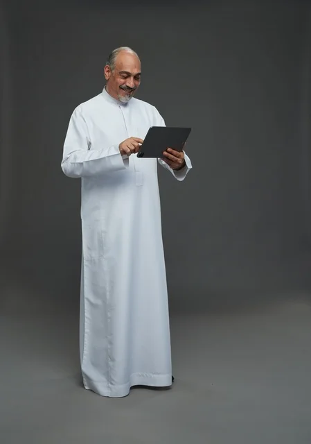 Senior Saudi Man Using Digital Tablet in Studio Portrait