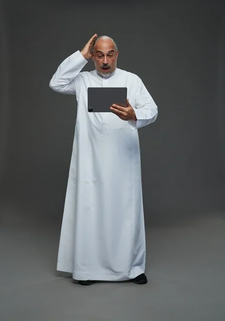 Elderly Saudi Man with Tablet Expression of Shock