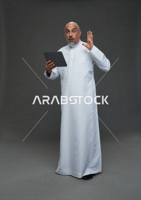 Senior Saudi Man Using Tablet with Surprised Expression