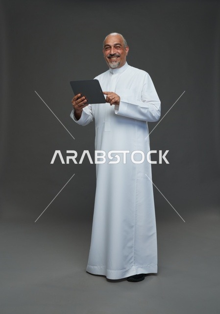 Senior Saudi Man Using Tablet in Studio