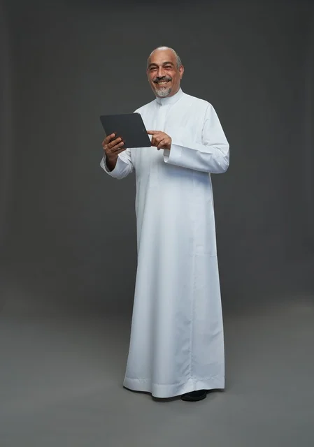 Senior Saudi Man Using Tablet in Studio
