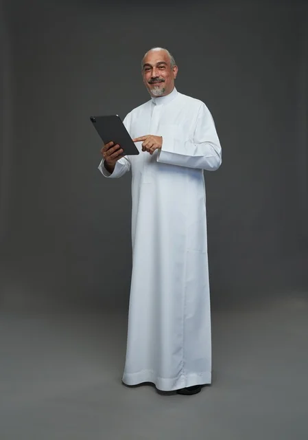 Senior Saudi Man Using Tablet in Studio