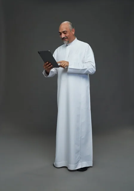 Elderly Saudi Man Using Digital Tablet in Studio