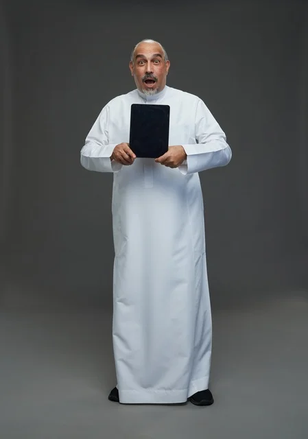 Surprised Senior Saudi Man Using Digital Tablet