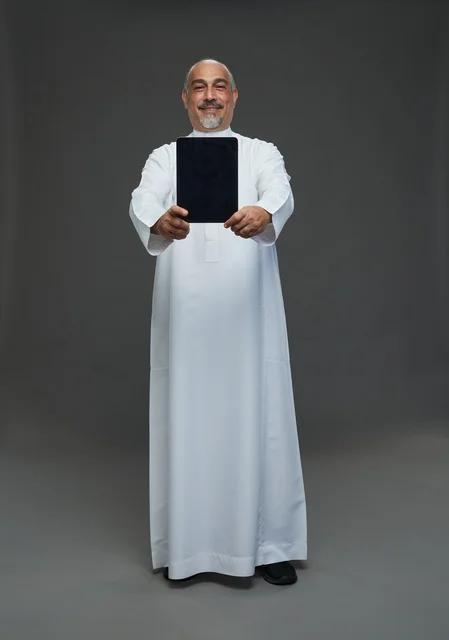 Senior Saudi Man Holding Digital Tablet in Studio Portrait