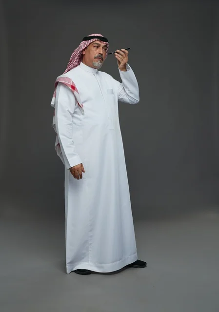 Elderly Saudi Man with Smartphone in Studio
