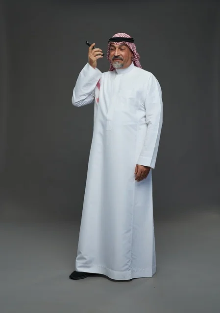Elderly Saudi Man Smiling While Talking on Phone