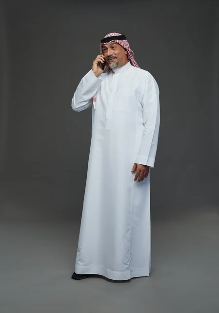 Elderly Saudi Man Smiling While Talking on Phone