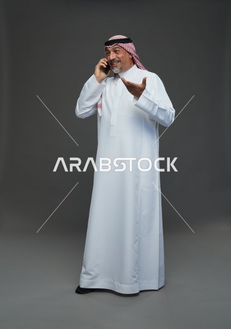 Saudi Elderly Man Smiling on Mobile Phone