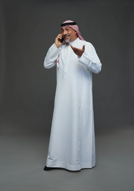 Saudi Elderly Man Smiling on Mobile Phone