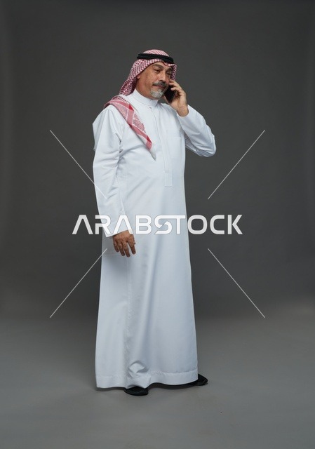 رجل سعودي مسن يتحدث بالهاتف في استوديو