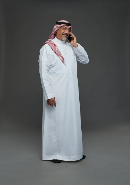 Senior Saudi Man Talking on Phone in Studio