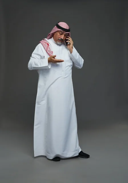 رجل سعودي مسن يتحدث بالهاتف في استوديو