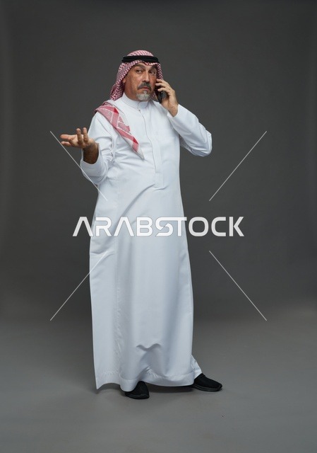 رجل سعودي مسن يتحدث بالهاتف في استوديو