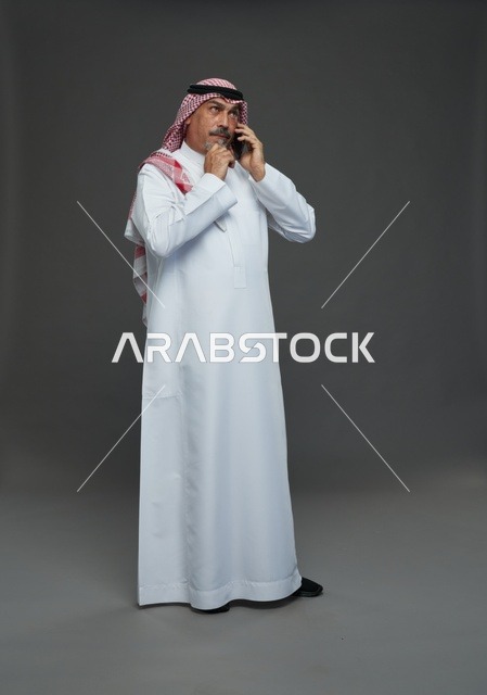Elderly Saudi Man Talking on Smartphone in Studio Portrait