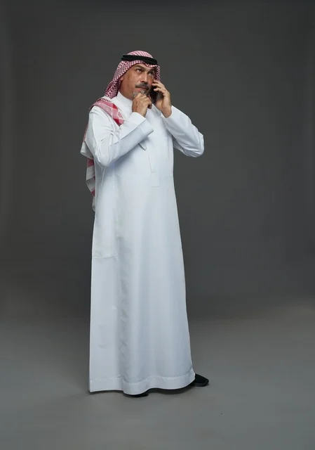 Elderly Saudi Man Talking on Smartphone in Studio Portrait