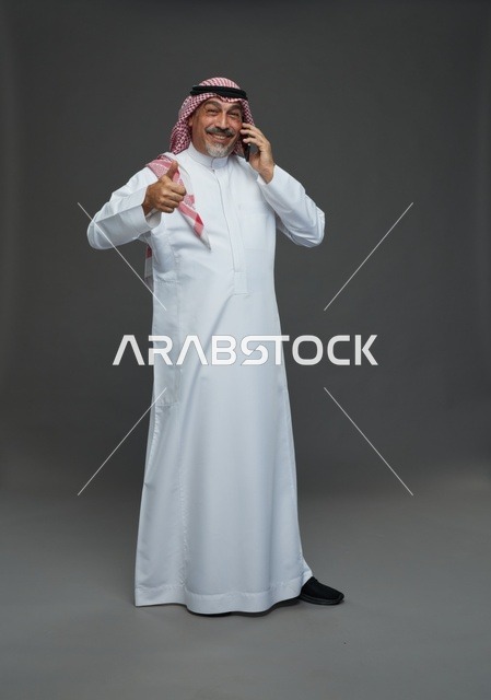 Elderly Saudi Man Smiling While Talking on Mobile Phone
