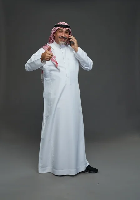 Elderly Saudi Man Smiling While Talking on Mobile Phone