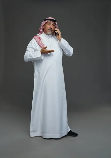 Elderly Saudi Man Talking on Smartphone in Studio