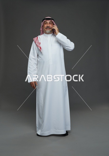 Saudi Senior Man Smiling While Talking on Phone