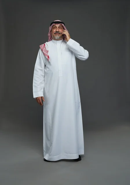 Saudi Senior Man Smiling While Talking on Phone