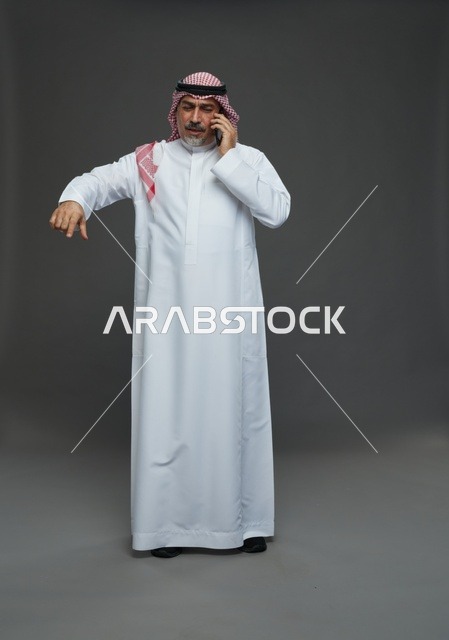 Elderly Saudi Man Talking on Mobile Phone in Studio